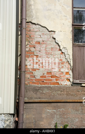 damaged plaster on building wall Stock Photo