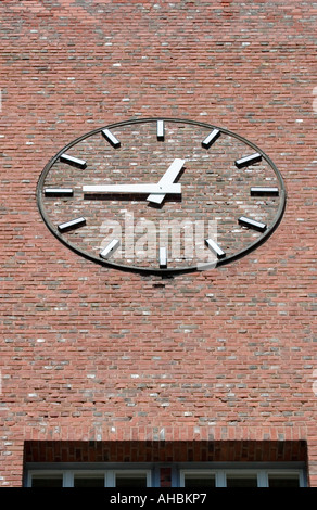 clock on red brick wall Stock Photo