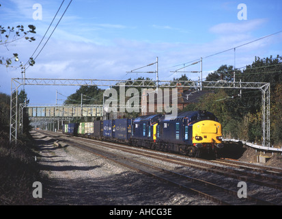 A pair of DRS class 37 locomotives with an intermodal freight near Cathiron on 7th October 2003. Stock Photo
