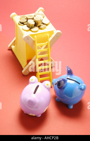 Piggy Banks with Miniature Ladder and Coins Stock Photo