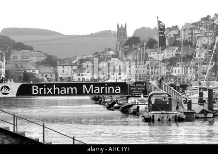 Monochrome view of Brixham Harbour and marina with the town and church behind Stock Photo