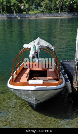 A boat moored on the shore of Lake Como, Italy Stock Photo
