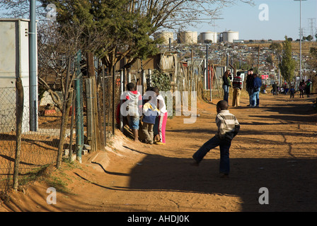 Children in a South African shanty town gather to count the money they have received from travellers Stock Photo