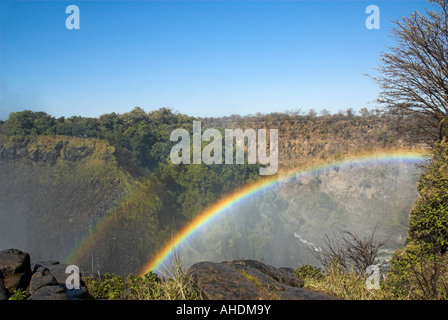 Rainbow in the mist at Victoria Falls Stock Photo