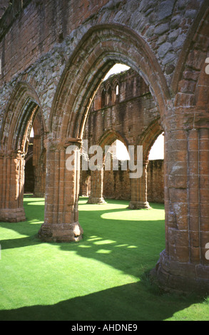 View through the arches on the north side of the nave of Sweetheart Abbey Church in New Abbey, Dumfries and Galloway, Scotland. Stock Photo