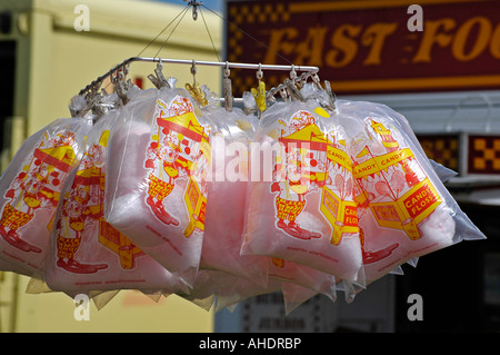 candy floss in bags hanging from a stall at a fairground Stock Photo