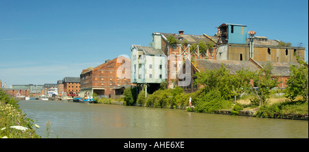 Old Mill waiting redevelopment Refurbished warehouses in the distance Gloucester Docks Stock Photo