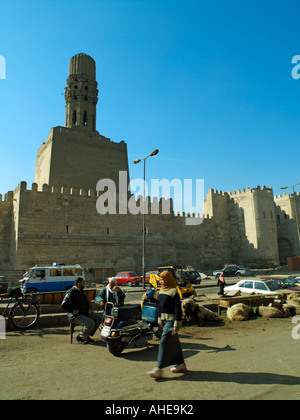 Life passing beneath the Northern Walls of Cairo and Al Hakims minaret Stock Photo