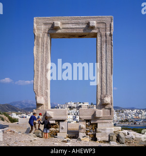 Square arched Temple of Apollo with family visiting and Naxos town beyond Naxos Island The Greek Islands Greece Stock Photo