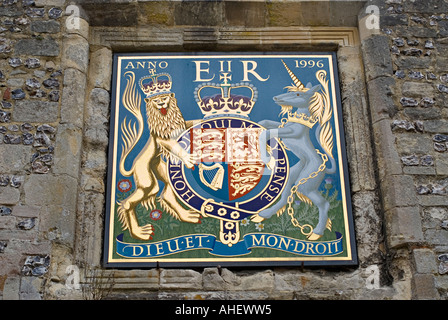 Royal Crest of Queen Elizabeth II above Priors Gate adjacent to Winchester Cathedral Hampshire England Stock Photo