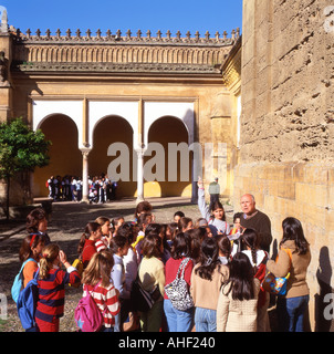 Children on a cultural school trip with a tour guide and teacher visiting the Mezquita Mosque in Cordoba Andalucia Southern Spain  KATHY DEWITT Stock Photo