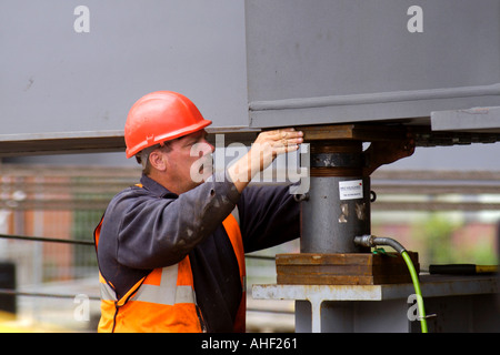 Working on the directional guides and jacking points of a road bridge being winched over the River Usk at Newport South Wales UK Stock Photo