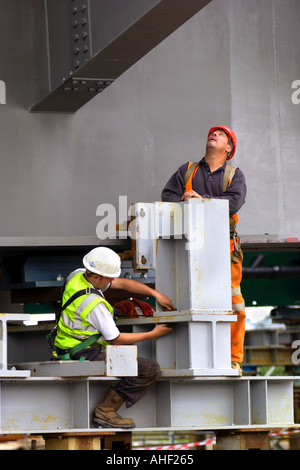 Working on the directional guides and jacking points of a road bridge being winched over the River Usk at Newport South Wales UK Stock Photo