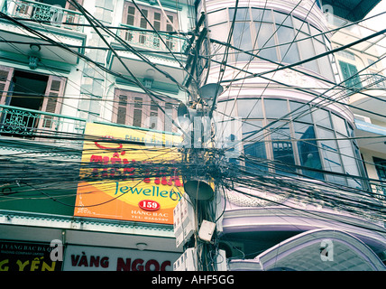 Crazy telephone wiring in the Old City of Hanoi in Vietnam in Far East Southeast Asia. Telecom Telecommunication Street Scene Urban Slum Travel Stock Photo