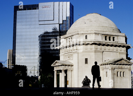 A businessman walks past the Hall of Memory in Centenary Square Birmingham UK Stock Photo