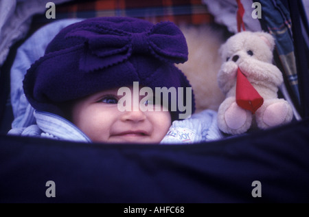 A baby looks out from her pram, London, UK. Stock Photo