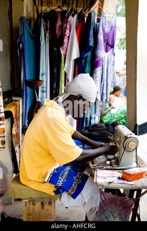 Tailor at work on his stall in the Senegambia Craft Market, Kololi,The Gambia, Africa Stock Photo