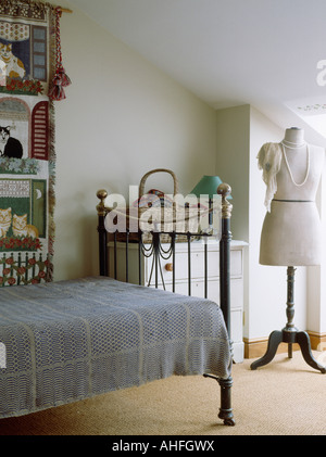 A bedroom with a single bed and a mannequin Stock Photo - Alamy