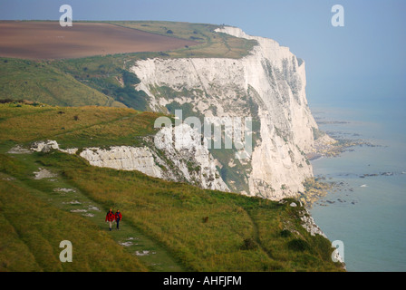 Couple walking on cliff path, The White Cliffs, Dover, Kent, England, United Kingdom Stock Photo