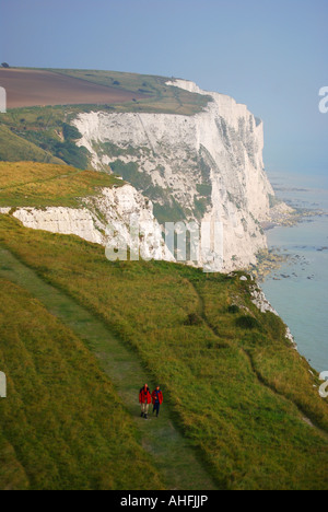 Couple walking on cliff path, The White Cliffs, Dover, Kent, England, United Kingdom Stock Photo