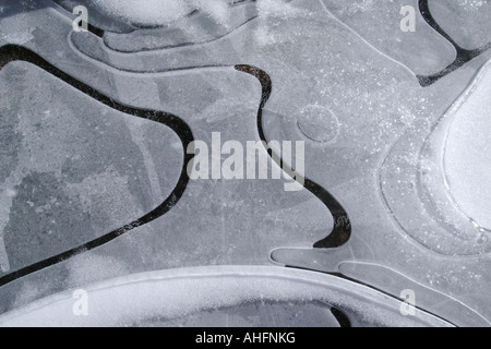 Close up of ice patterns formed by air bubbles under the frozen surface of a pond Stock Photo