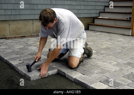 Working laying concrete pavers for patio Stock Photo