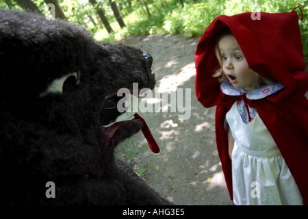 little red riding hood meets the wolf on the path Stock Photo