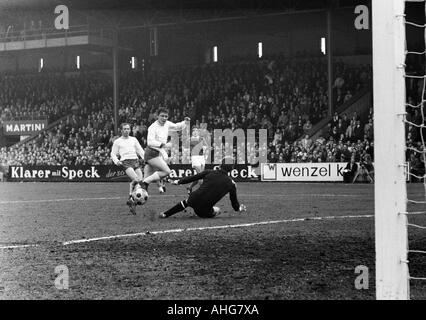 football, Bundesliga, 1969/1970, FC Schalke 04 versus Rot-Weiss Oberhausen 2:2, Glueckaufkampfbahn Stadium in Gelsenkirchen, scene of the match, f.l.t.r. Hugo Dausmann, Werner Ohm (both Oberhausen), Hans Juergen Becher, keeper Norbert Nigbur (both Schalke Stock Photo