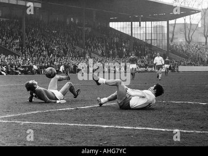 football, Bundesliga, 1969/1970, FC Schalke 04 versus Rot-Weiss Oberhausen 2:2, Glueckaufkampfbahn Stadium in Gelsenkirchen, scene of the match, Hans Juergen Becher (Schalke) left and Franz Krauthausen (Oberhausen) after a duel aground Stock Photo