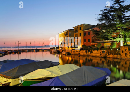 Small harbour and hotels at dusk in Sirmione, Lake Garda, Italy Stock Photo