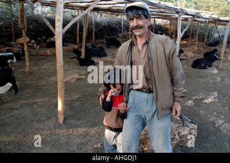 Kurdish nomad with his son tending his sheep and goats up in the hills of Southern Turkey near Kas. Stock Photo