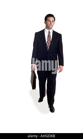 A business man walks with briefcase in studio. Stock Photo