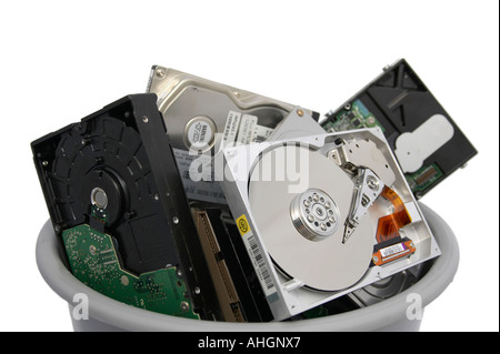 Pile of old broken open hard discs in a grey bin against a white background Stock Photo