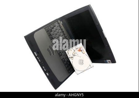 laptop and open broken hard drive against a white background Stock Photo