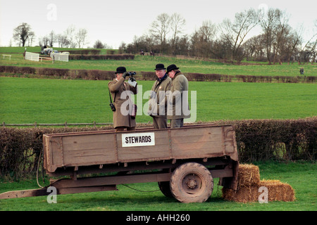 Horse racing stewards stand in a farm trailer to watch the racing at point to point meeting in Herefordshire England UK Stock Photo