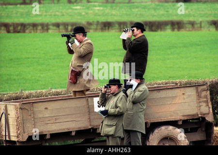 Horse racing stewards stand in a farm trailer to watch the racing at point to point meeting in Herefordshire England UK Stock Photo