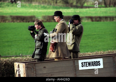 Horse racing stewards stand in a farm trailer to watch the racing at point to point meeting in Herefordshire England UK Stock Photo