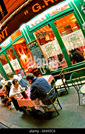 PARIS France, Men Sharing Meals at Regional French Restaurant, 'GR5 Savoyard' on Terrace Outside, Street at Night Stock Photo