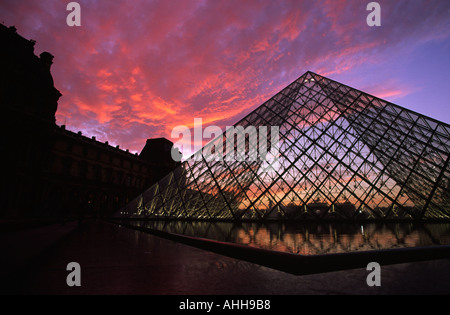 Red sky above The Pyramide at sunset at the Louvre in Paris France Stock Photo