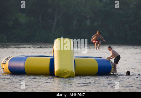 Boy Inflatable Raft Boys playing on an inflatable raft in a lake Stock Photo - Alamy