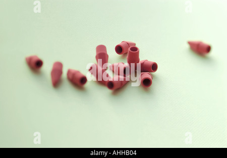 many pencil erasers form a design or pattern on simple surface Stock Photo