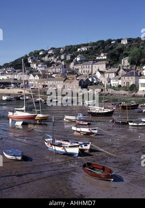 Mousehole harbour at low tide with village beyond