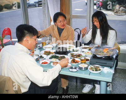 Friends eating meal in typical restaurant in South Korea