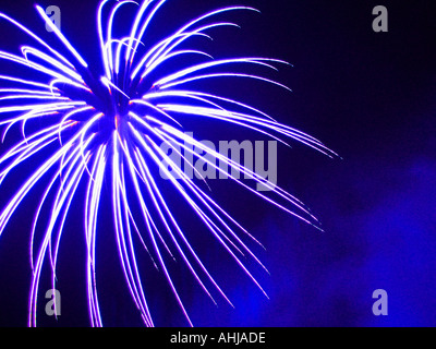 Firework exploding against a dark blue background Stock Photo