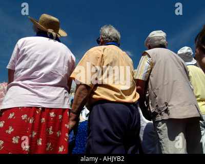 three elderly people in St Peters Square seen from behind Stock Photo