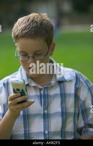 teenager using mobile phone text messages Telecommunications mobile hand cell phone cellphone telephone digital text me Stock Photo