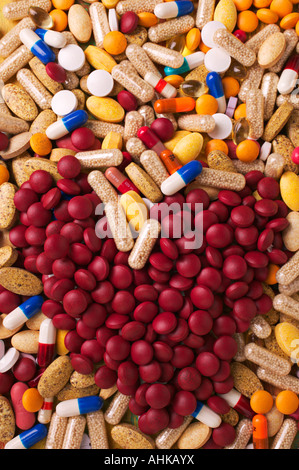 Assorted pills and a pile of red pills in heart shape Stock Photo