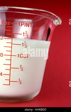 Milk in a glass measuring cup Stock Photo