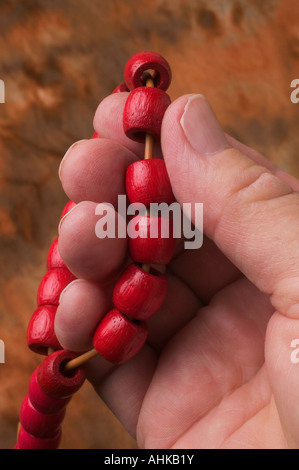 A man s hands holding worry beads Stock Photo