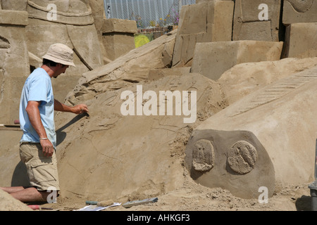 Artist at work at the world sand sculpting festival on Brighton beach in the south of England Stock Photo